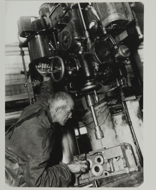 Nikolai Filippov at his lathe in the works from the photo-essay A Day in the Life of a Moscow Worker Family