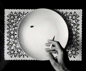 Hand With Cigarette, Pea on Plate, from the series Place Mat Photographs