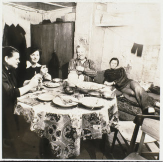Untitled (Four figures around a table)