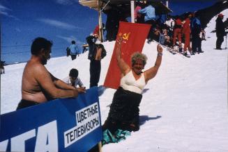 (Sun bathers on snowy hill)